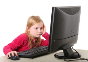 girl looking at computer monitor